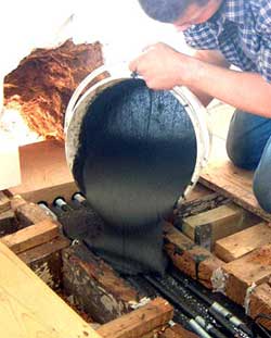 Pouring Structural Epoxy Resin into a dug out beam which forms the shutter box